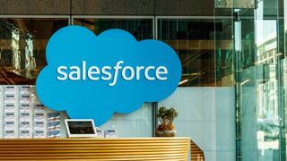 The Salesforce logo on a glass wall in an office building