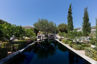 Samos Garden with pool in front of the main building and the guesthouse.