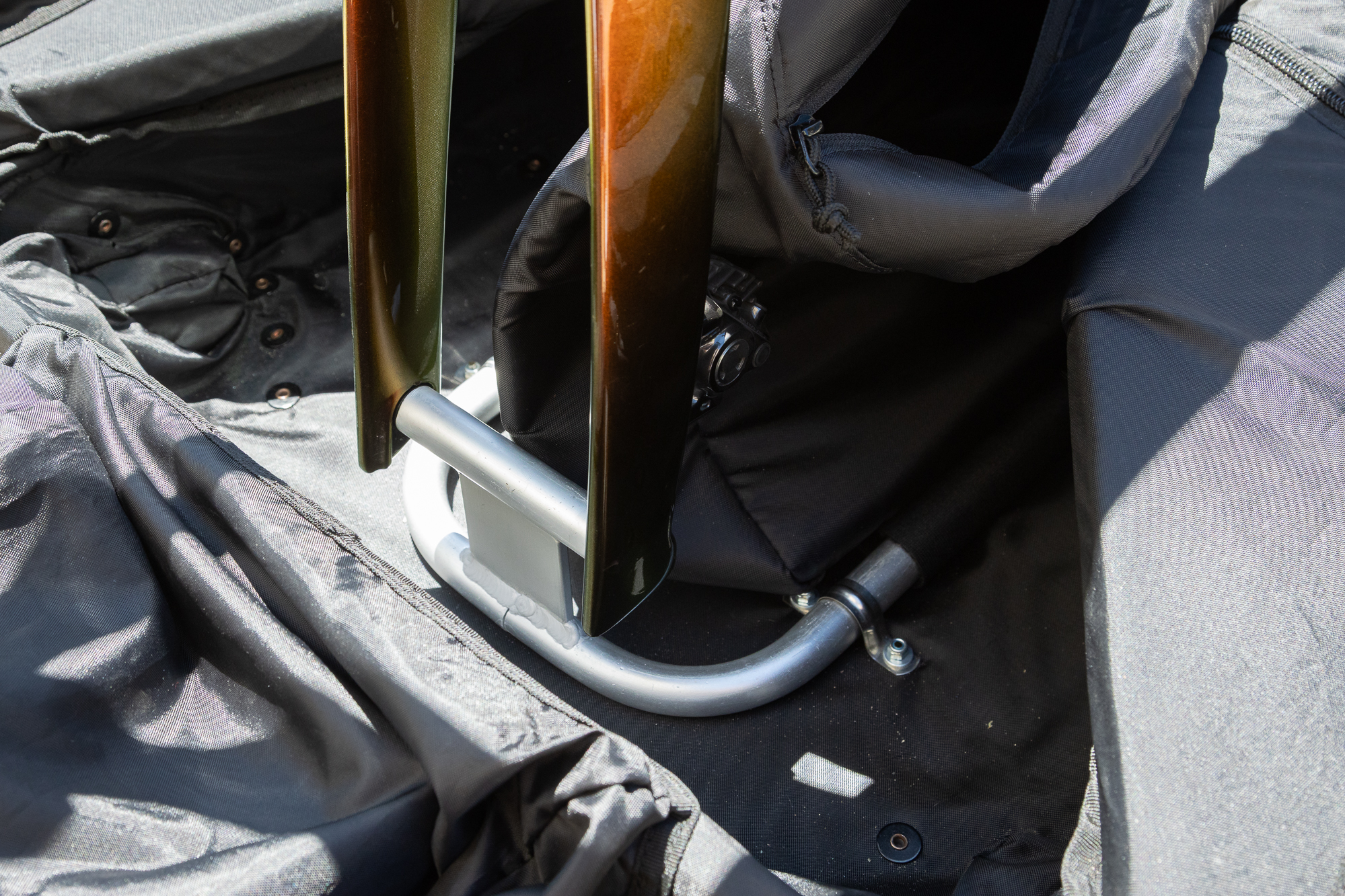 close up of some forks bolted to a metal frame inside the box