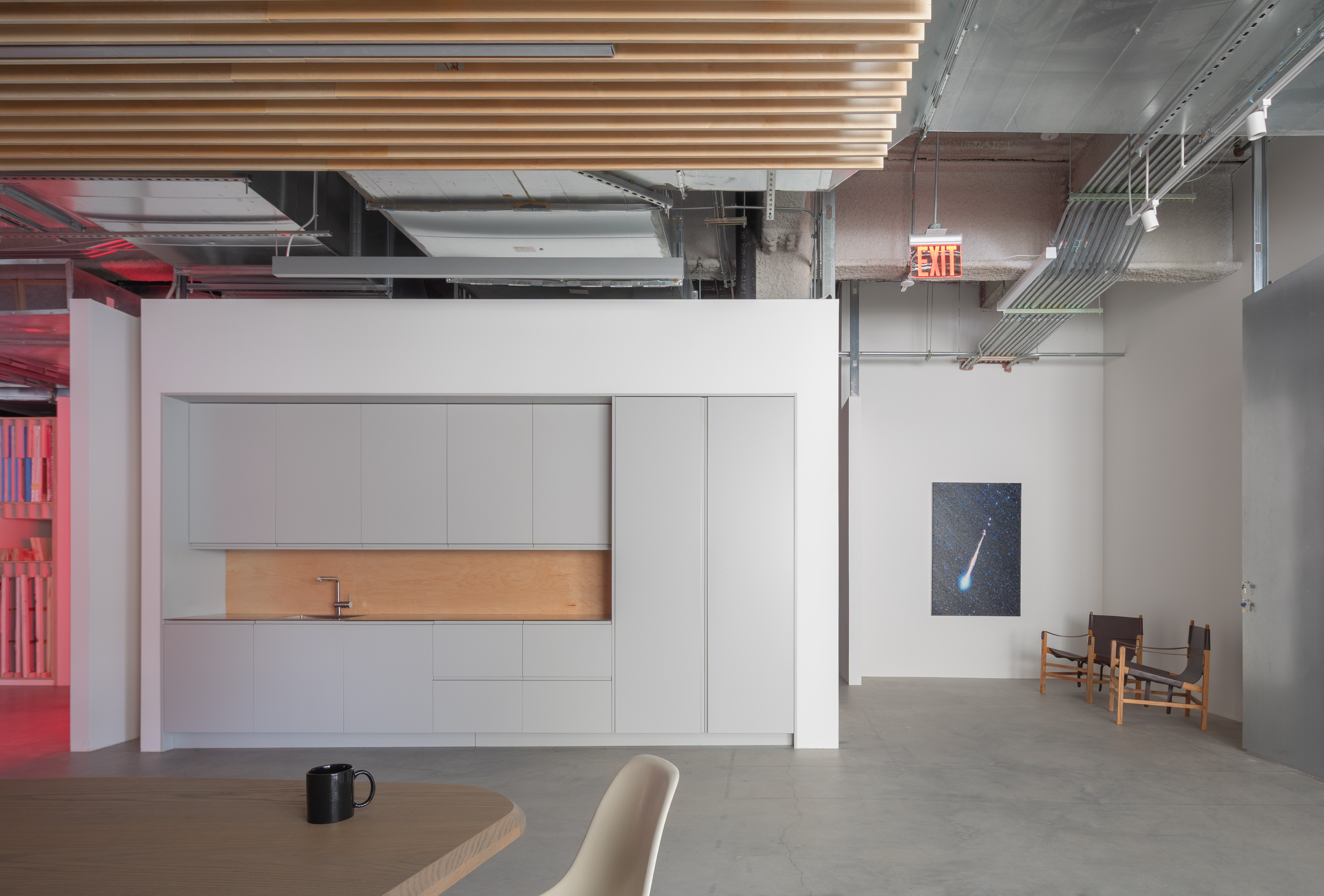 minimalist interior of artist Glenn Ligon's studio by Ravi Raj, with artworks and bespoke utilitarian furniture