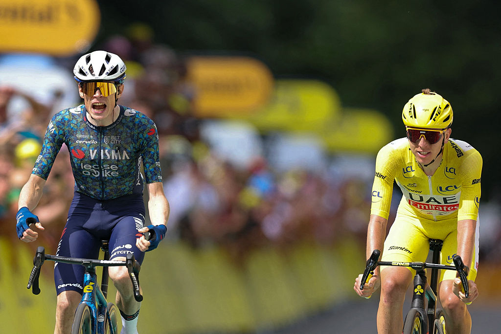 Team Visma - Lease a Bike team's Danish rider Jonas Vingegaard (L) cycles to the finish line to win ahead of UAE Team Emirates team's Slovenian rider Tadej Pogacar wearing the overall leader's yellow jersey (R) during the 11th stage of the 111th edition of the Tour de France cycling race, 211 km between &amp;Eacute;vaux-les-Bains and Le Lioran, on July 10, 2024. (Photo by Thomas SAMSON / AFP)