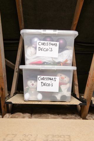 Clear plastic storage boxes in a loft