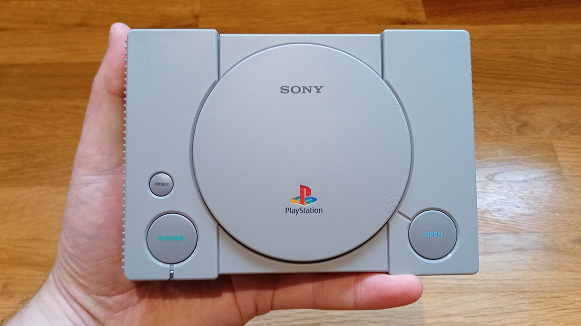 A photo of the PlayStation Classic on a wooden table