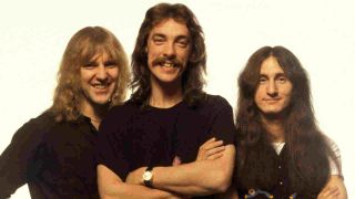 Rush posing for a photograph in 1976