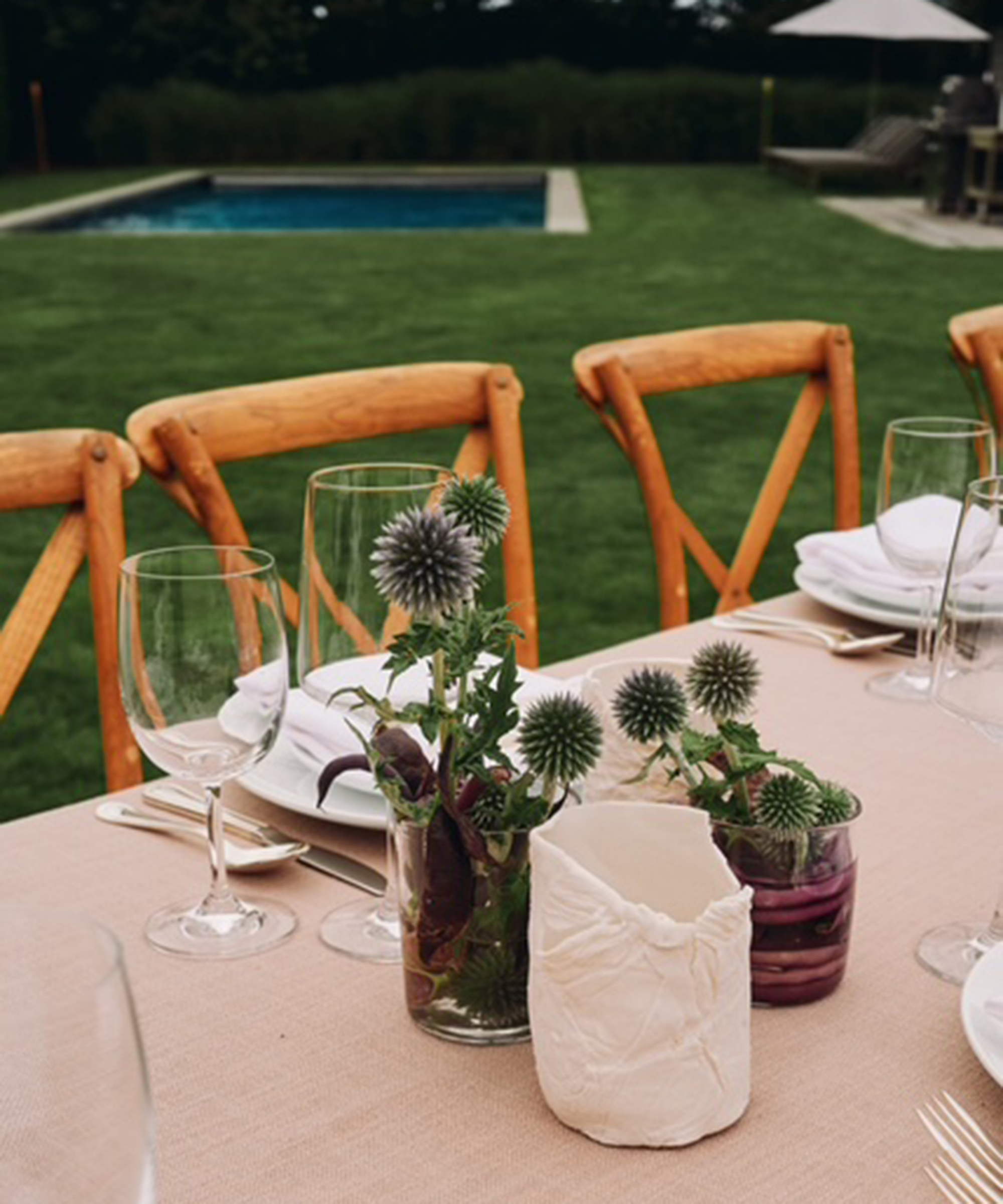 dining table with thistles in a vase