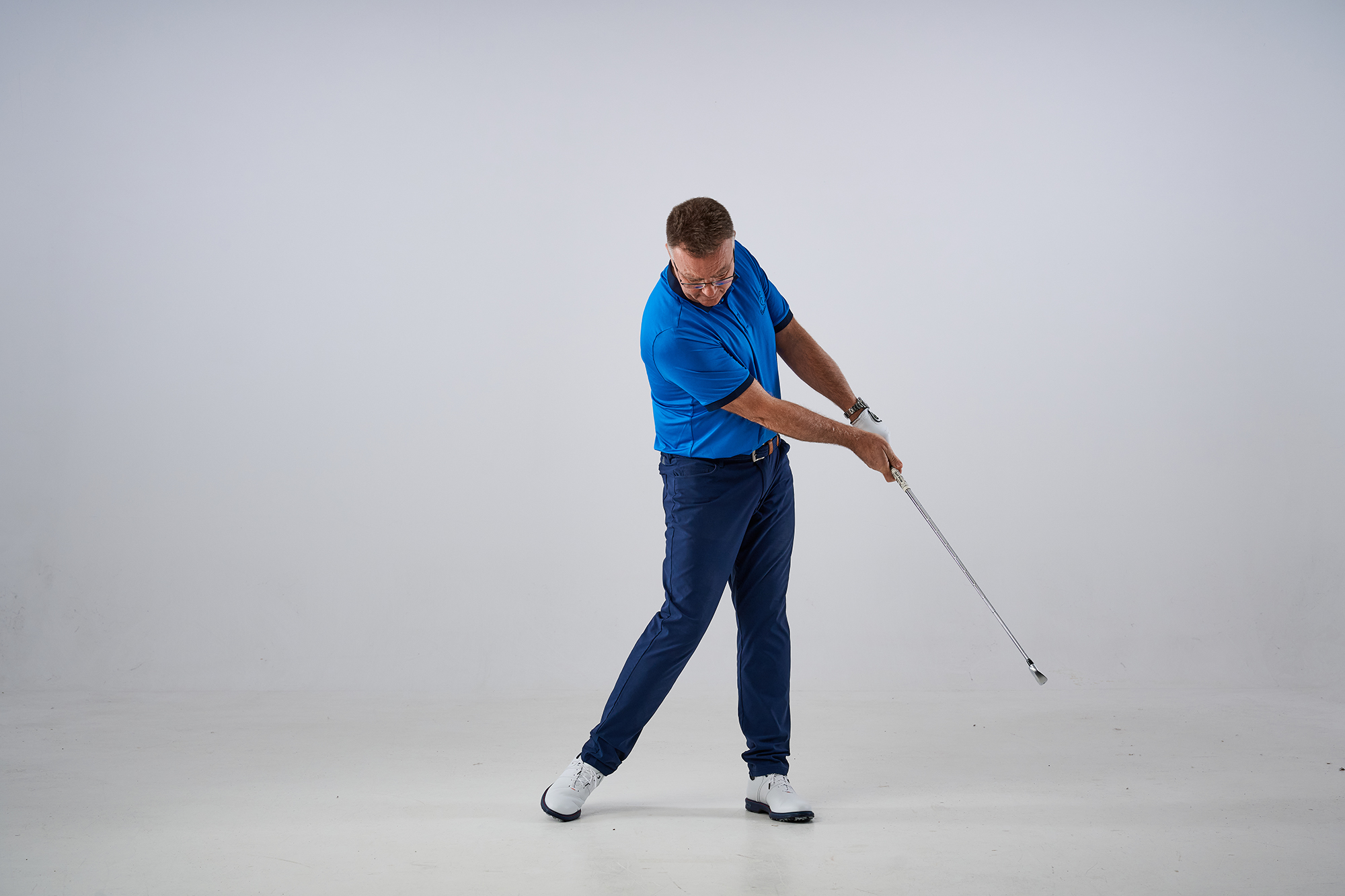 John Jacobs demonstrating a poor post-impact position where the golf club has been released ineffectively and is still pointing at the target