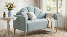 a living room with a couch, pillows, and decor