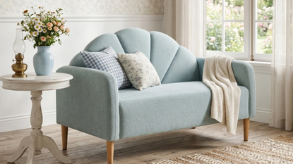 a living room with a couch, pillows, and decor