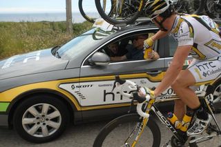 Bernhard Eisel takes on a turbo bidon from the HTC-Columbia car during stage three.