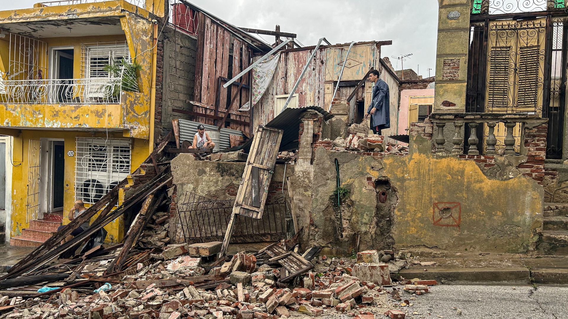 
                                Men search through the wreckage of their home after Hurricane Melissa tore through Santiago de Cuba, Cuba
                            