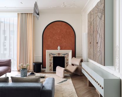 A living room area with bespoke touches, including a custom fireplace with a mosaic surround.