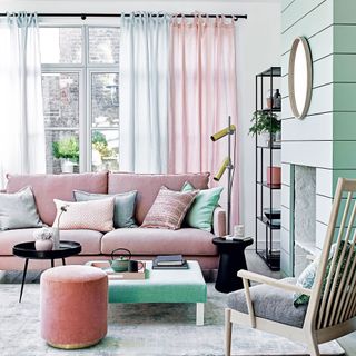 Green living room with pink sofa and pink and green sheer curtains