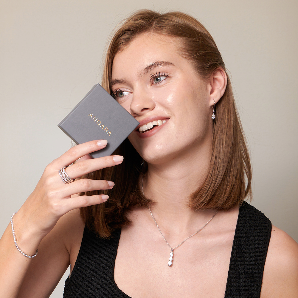 Woman holding an Angara jewelerry box