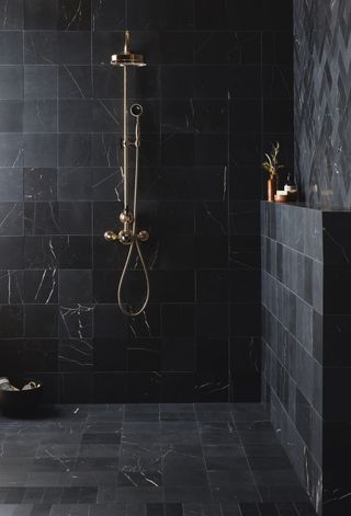 shower storage ideas black marble bathroom with built in shelf by Bert & May