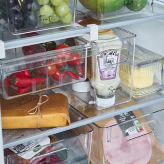 Fridge organisers filled with food on fridge shelves