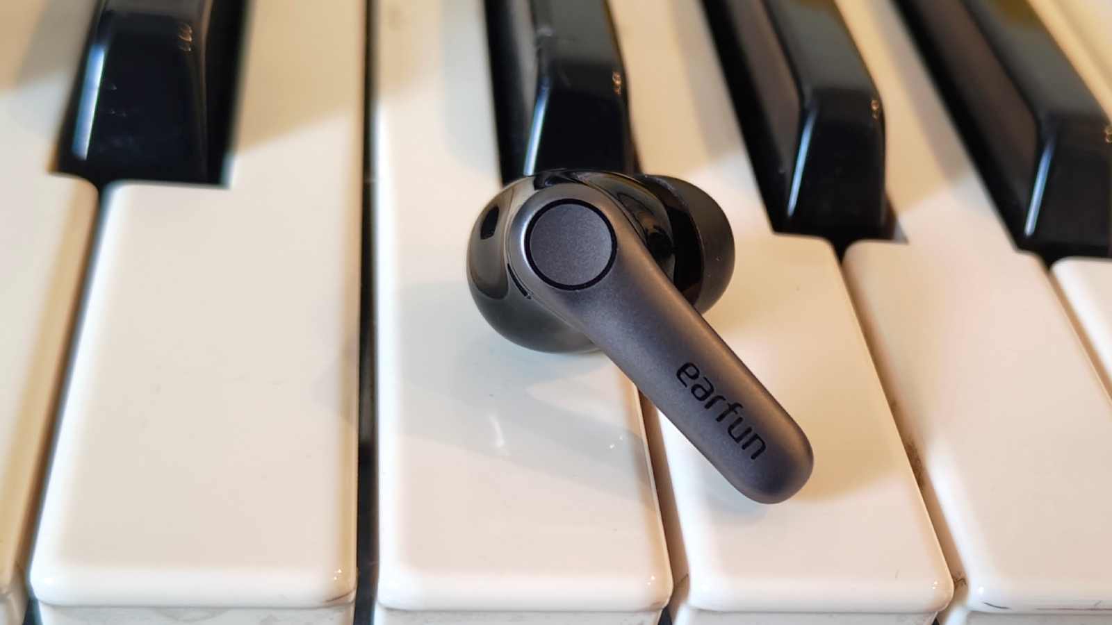 The Earfun Air Pro 4 Plus on top of a keyboard.
