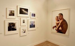 Corner of white room with framed photos