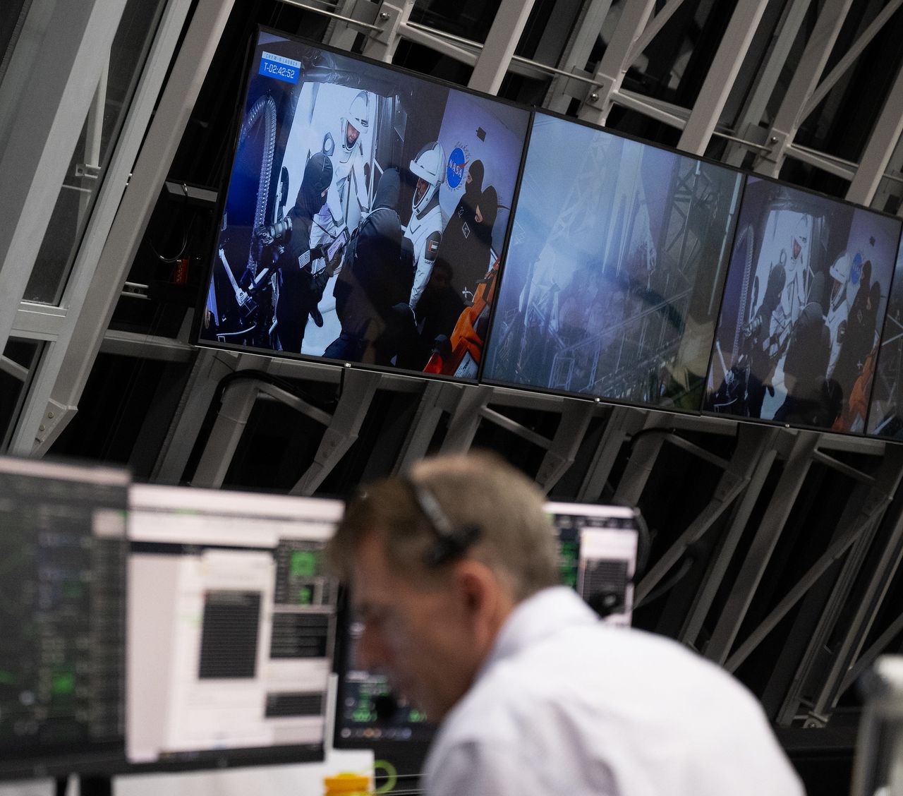 Video screens in a NASA launch facility show the Crew-6 astronauts getting into their Crew Dragon atop a SpaceX Falcon 9 rocket during a launch rehearsal on Feb. 24, 2023.