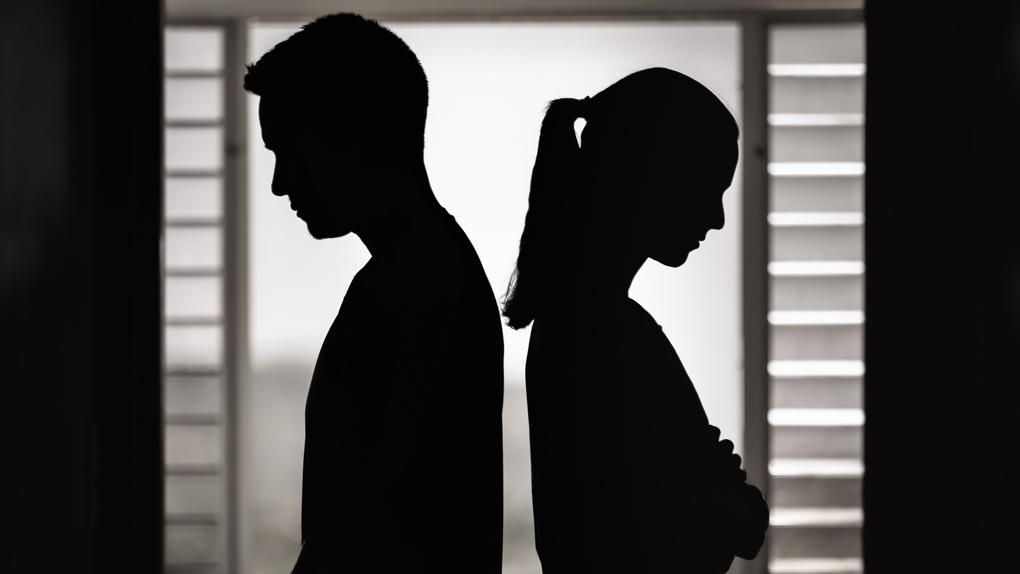 Couple in dark facing away from each other
