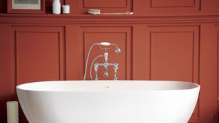 best bathroom color trend with terracotta wall behind freestanding white tub