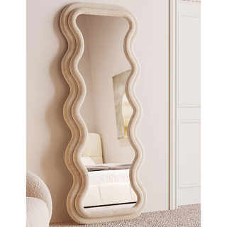 floor mirror with a beige wavy padded double frame