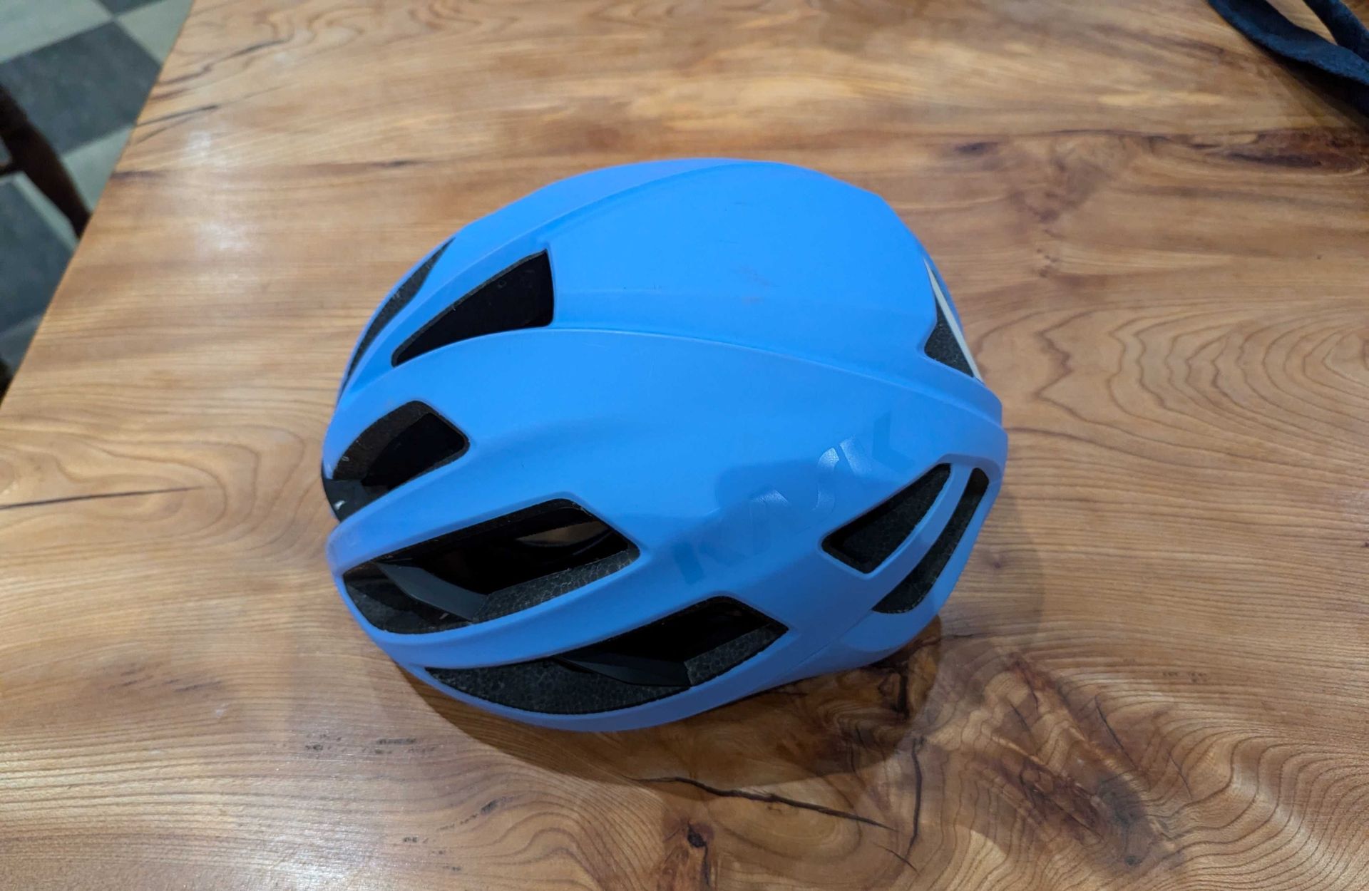 Kask Protone Icon Mips blue cycling helmet on wood background