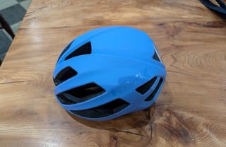 Kask Protone Icon Mips blue cycling helmet on wood background