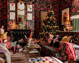 Christmas tree themes 2021 with red and gold decorations in a maximalist red, gold and black living room