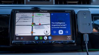 Carsifi Android Auto adapter next to Android Auto screen front view.