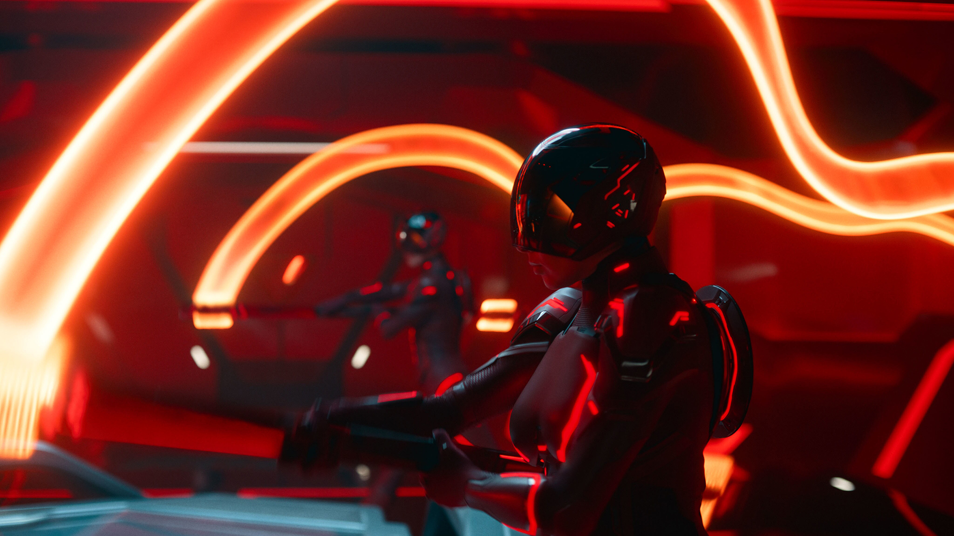 Still from the movie Tron: Ares. Two people are wearing black bodysuit and helmet (both trimmed with red light). They are each holding a device that is leaving a bright orange trail of light.