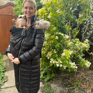 Our editor and tester, Anna, Bailey, wearing the River Island Maternity Hooded Puffer Coat 