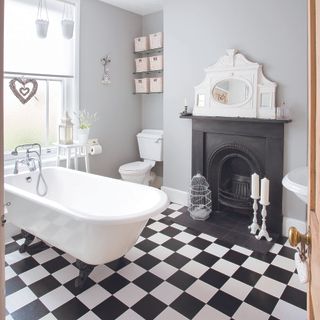 bathroom with white bathtub and candle stand and fireplace