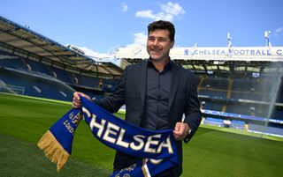 Chelsea Head Coach Mauricio Pochettino poses for the photographer with a club scarf after holding a Press Conference at Stamford Bridge on July 07, 2023 in London, England