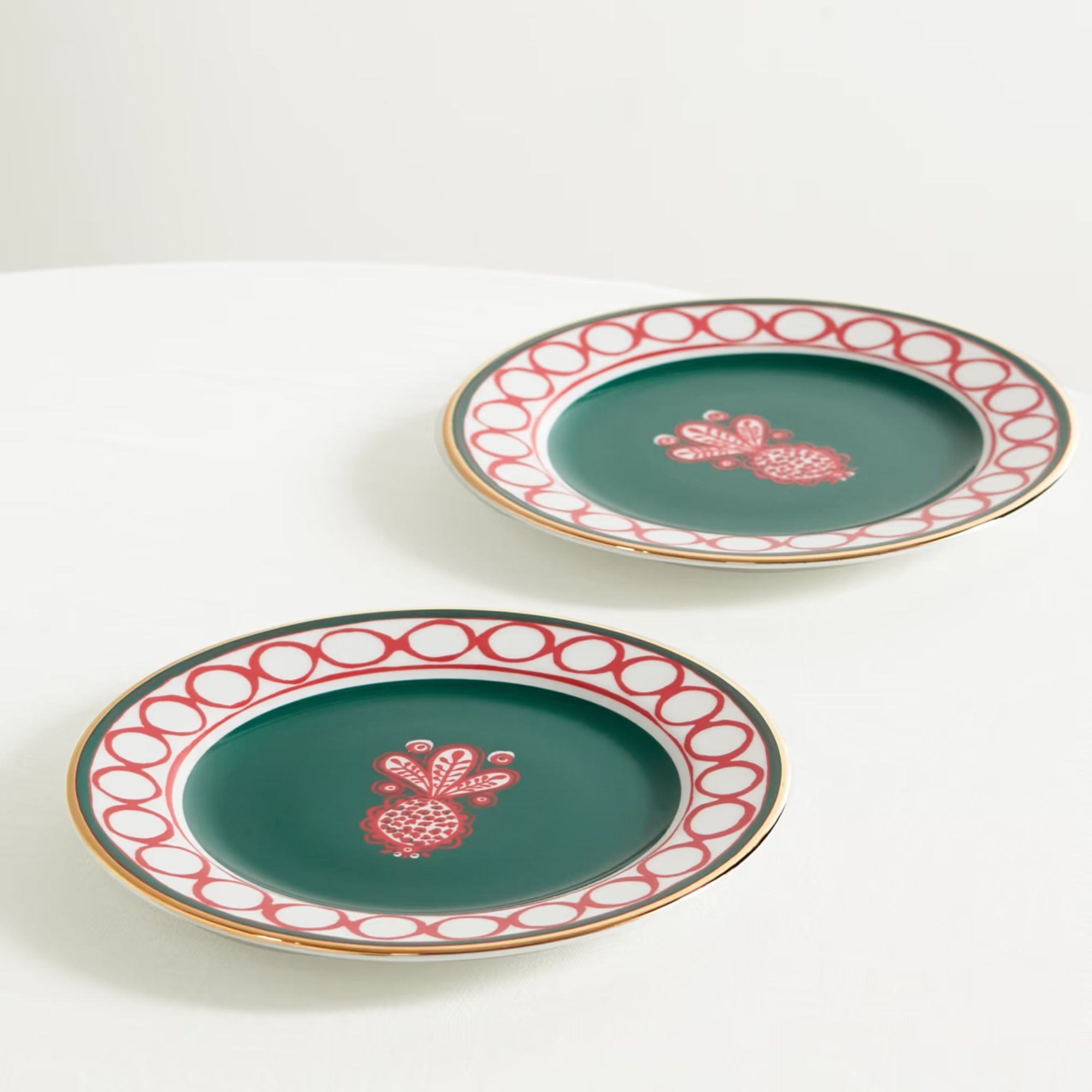Deep green dessert plates with pink and white rims