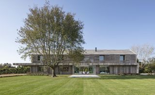 view of Hamptons house within green expanses