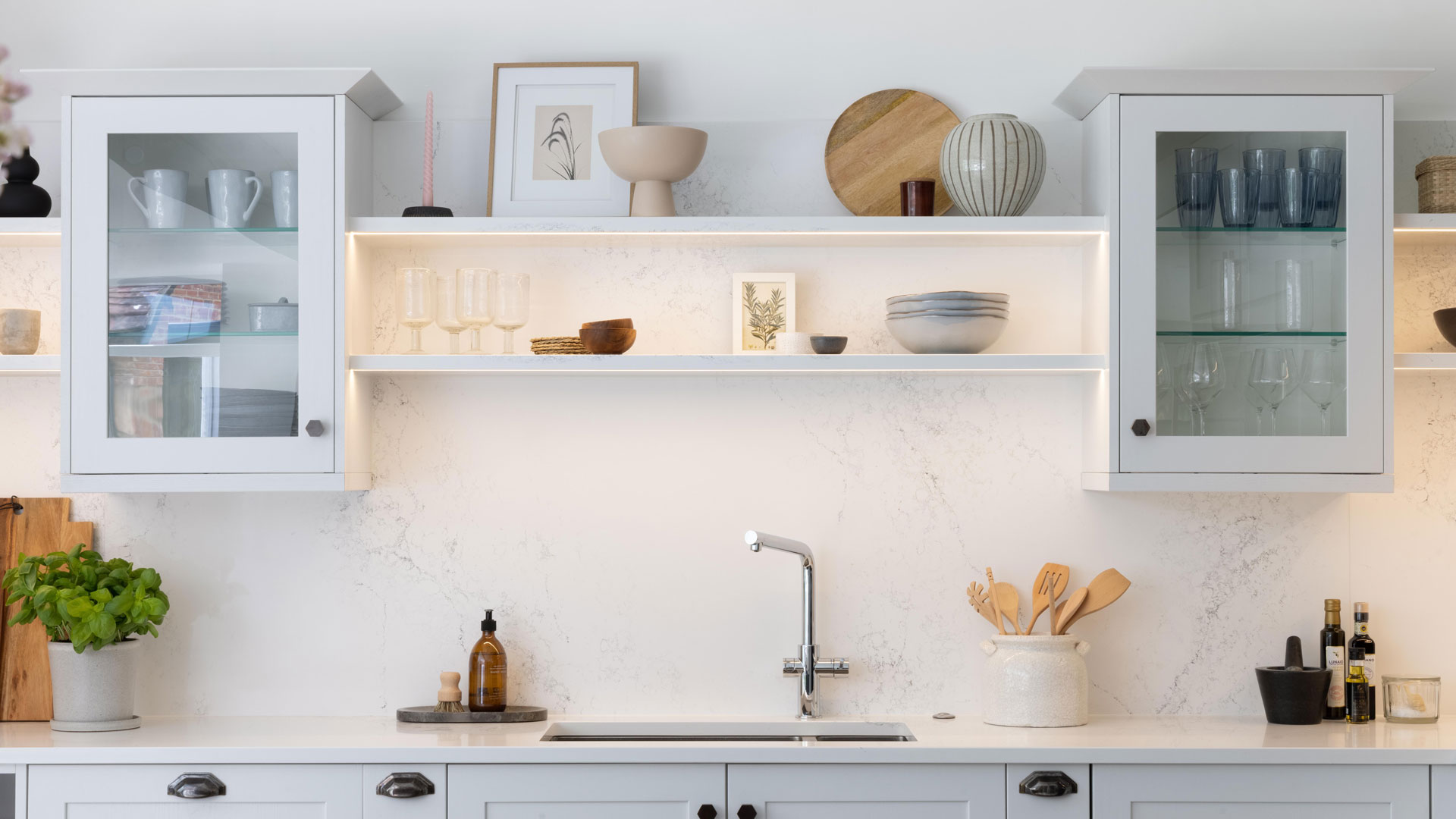white kitchen with glass-fronted wall units