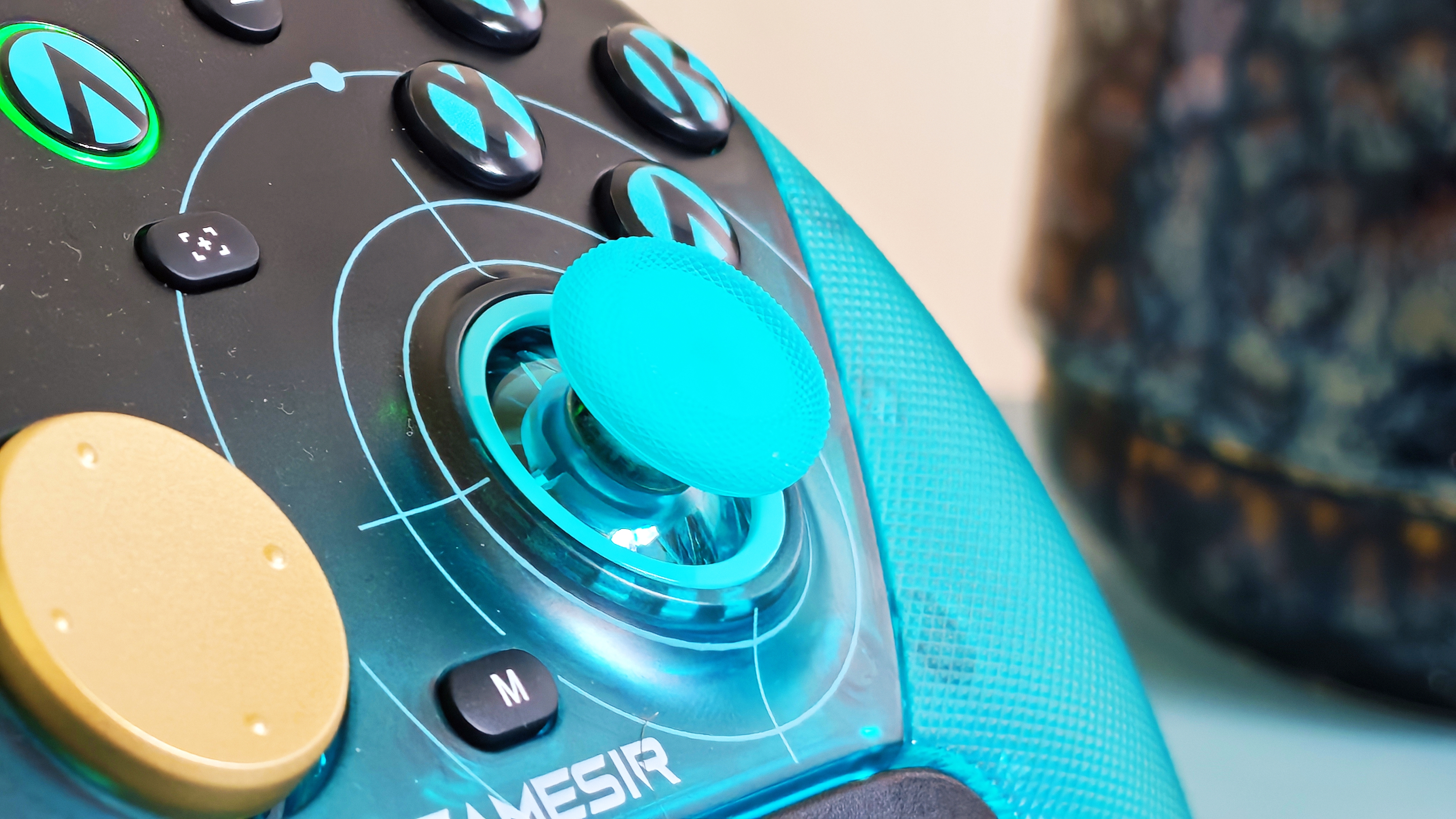 A cyan GameSir G7 Pro 8K controller on a blue table