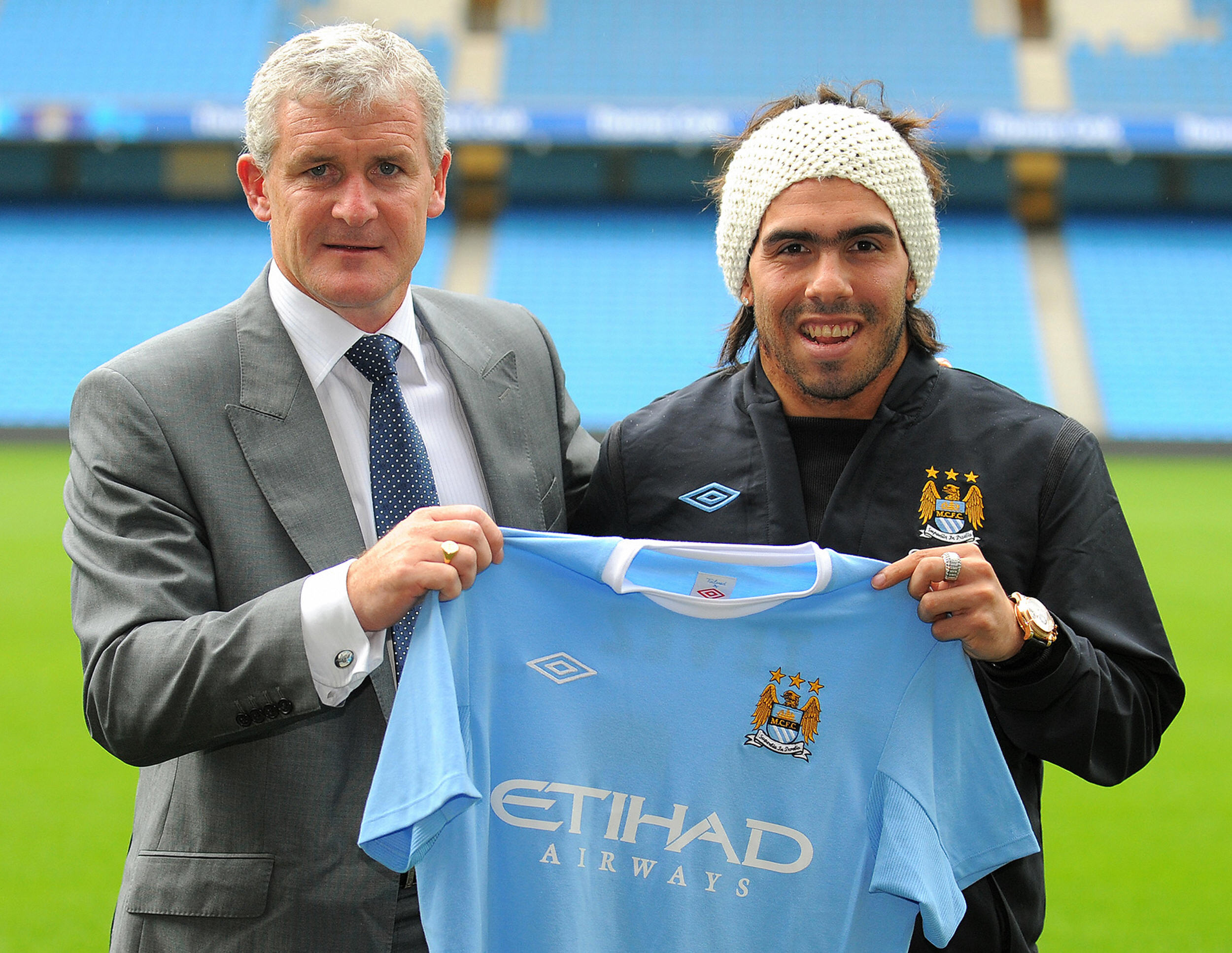 Carlos Tevez poses alongside Manchester City manager Mark Hughes after signing for the Sky Blues in July 2009, following a two-year spell at Manchester United.