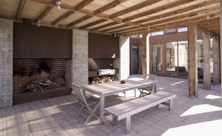 Covered pergolas form extended outdoor living rooms