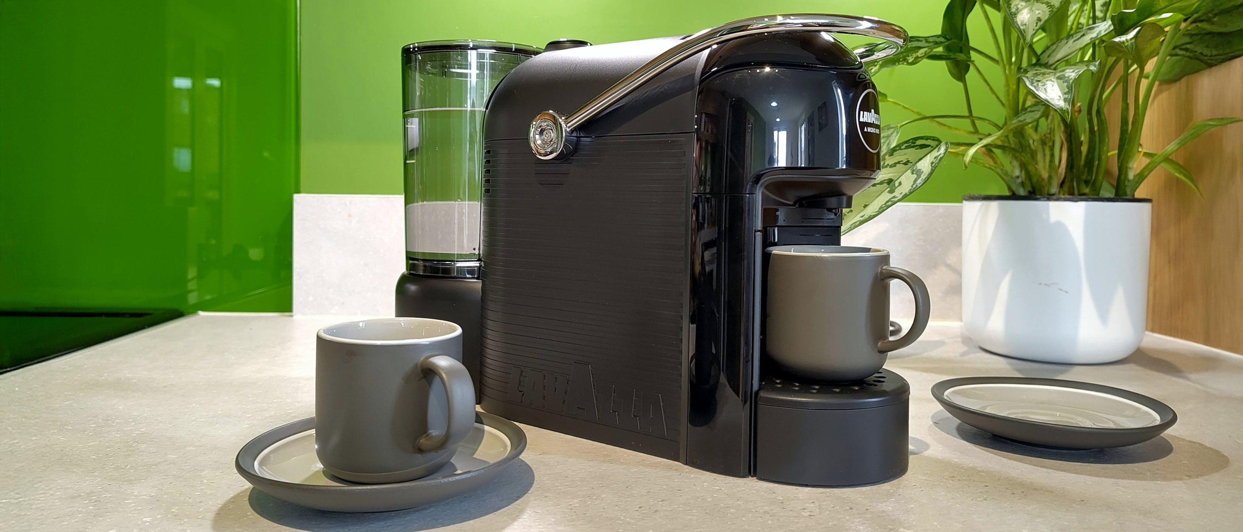 Lavazza Jolie Evo coffee maker on kitchen counter with espresso cups and saucers