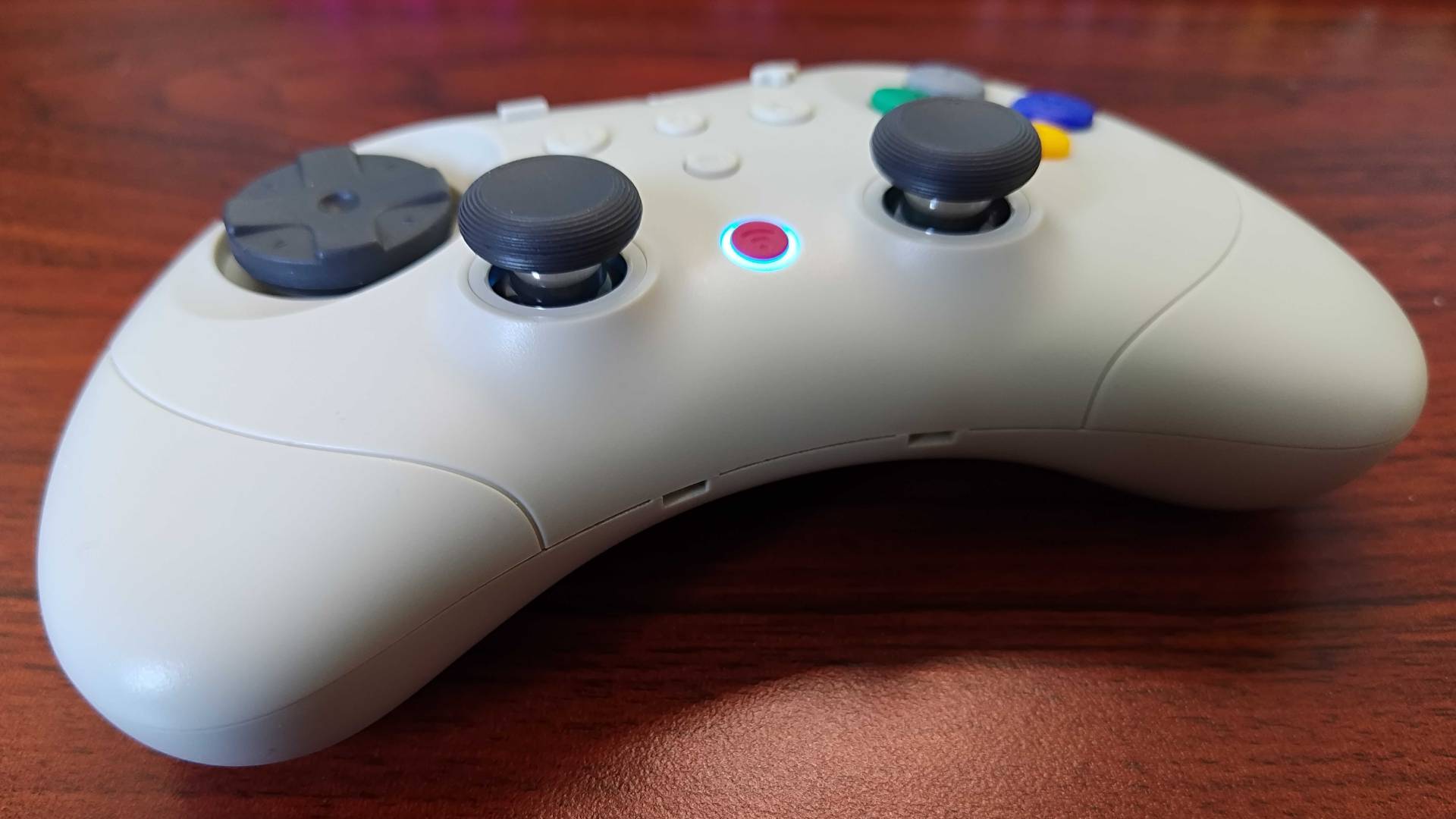 Close up of Gulikit Elves 2 Pro thumbsticks on woodgrain desk.