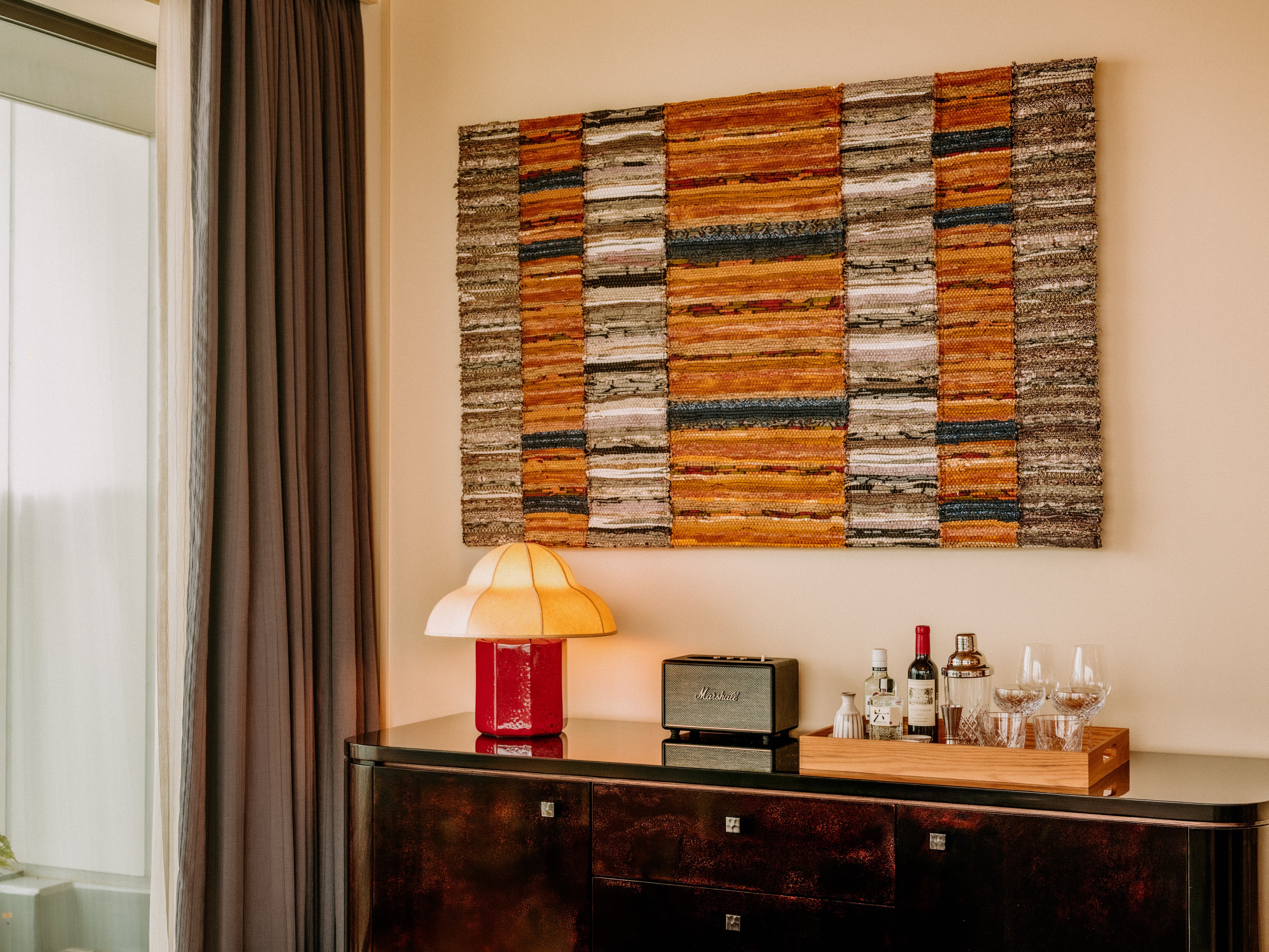 A private members' club with washi paper-clad walls, an earthy palette of reds, beige, greens, and oranges, and plenty of vintage furniture decorating its bedrooms, lounges, and restaurants.
