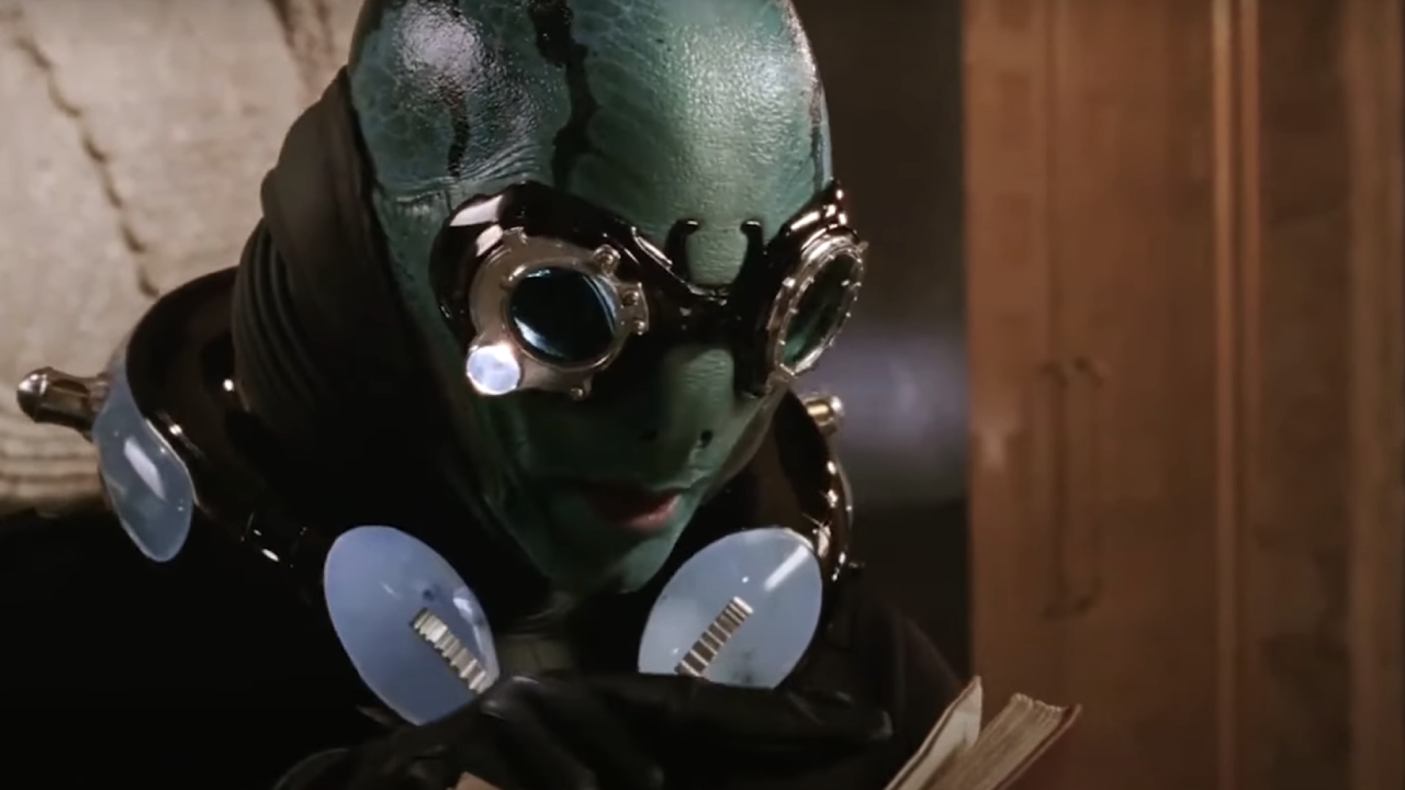 Doug Jones as Abe Sapien reading from a book in Hellboy