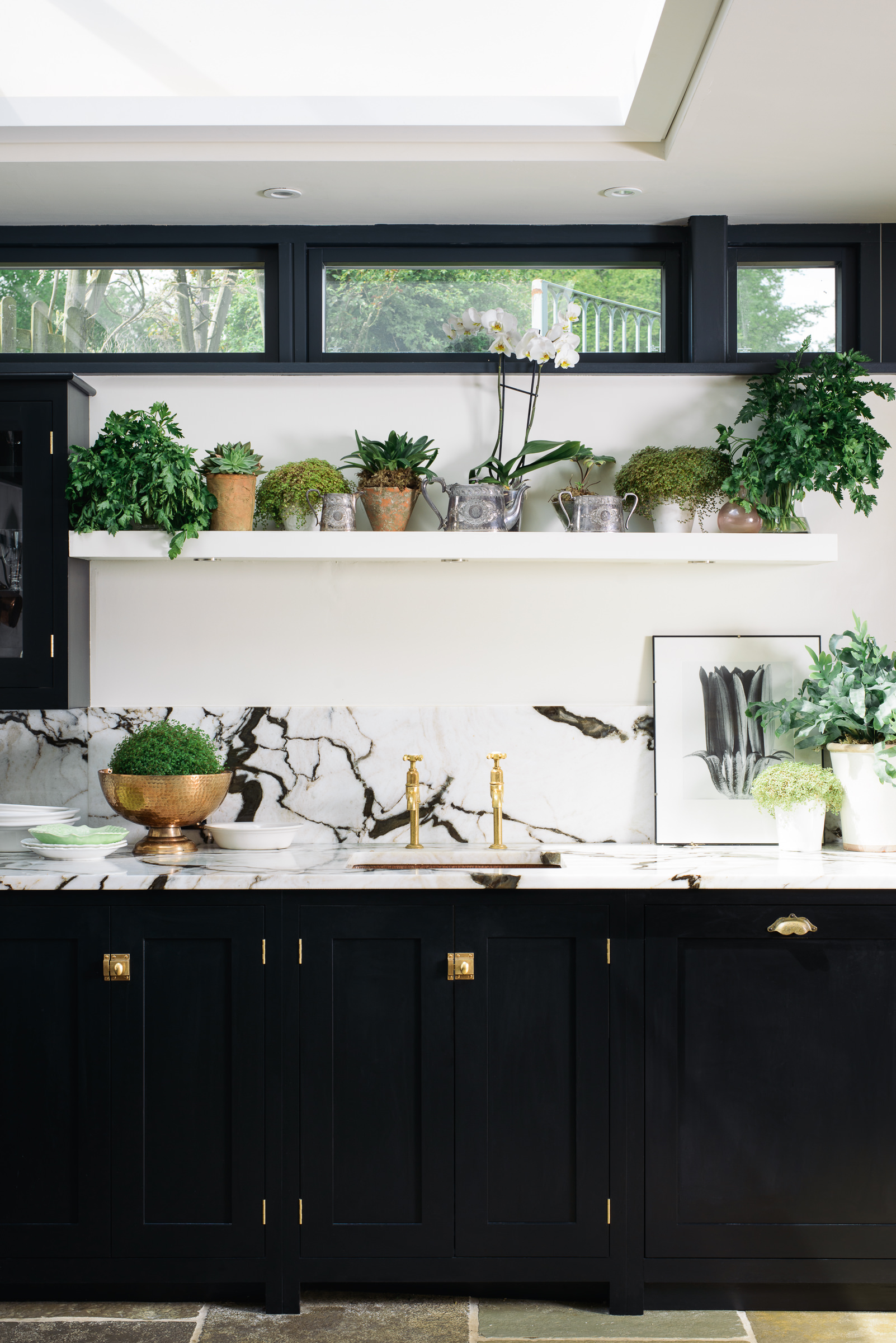 kitchen with pot plants on open shelving by deVOL