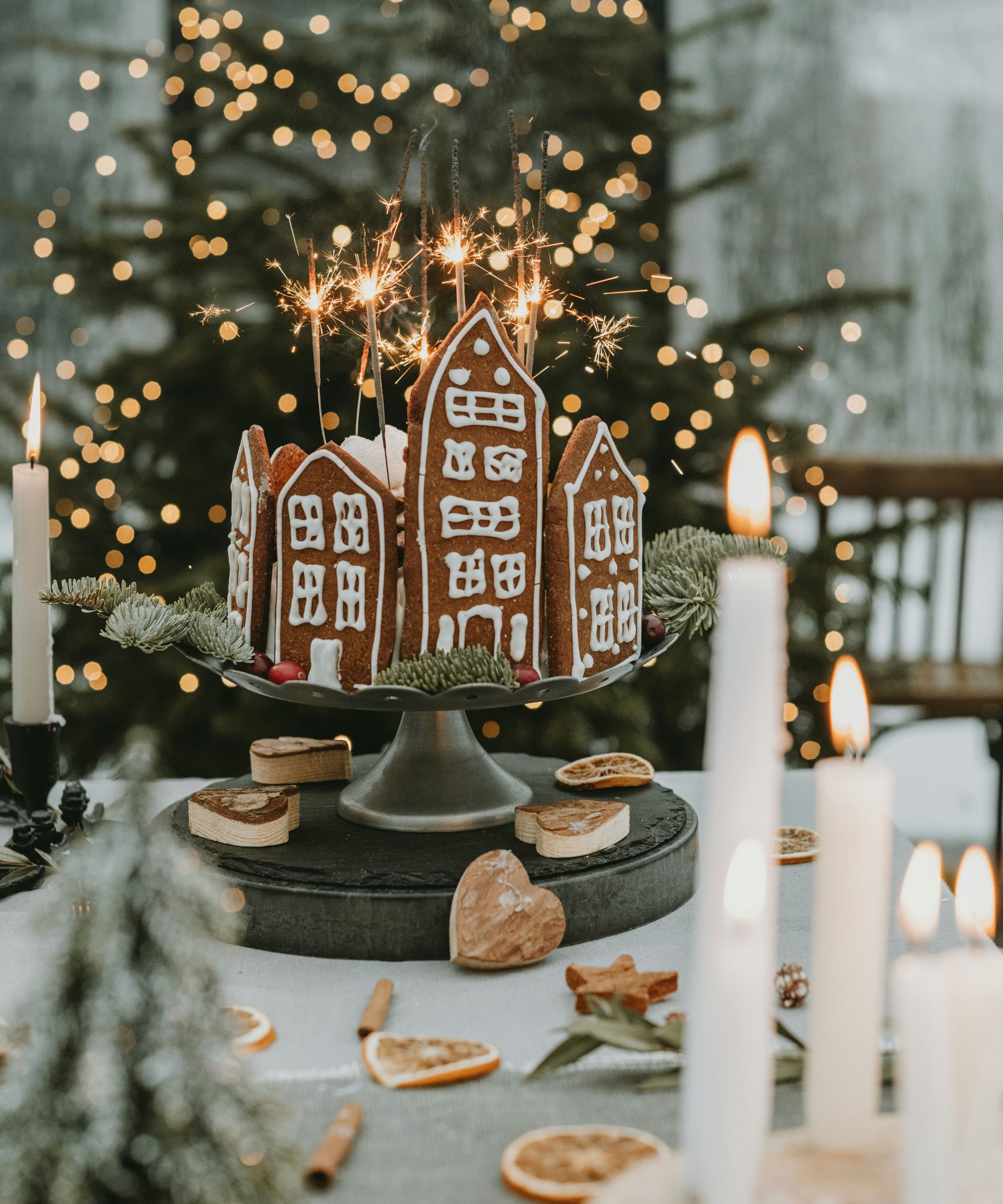 Christmas gingerbread house cake on a cake stand with sparklers
