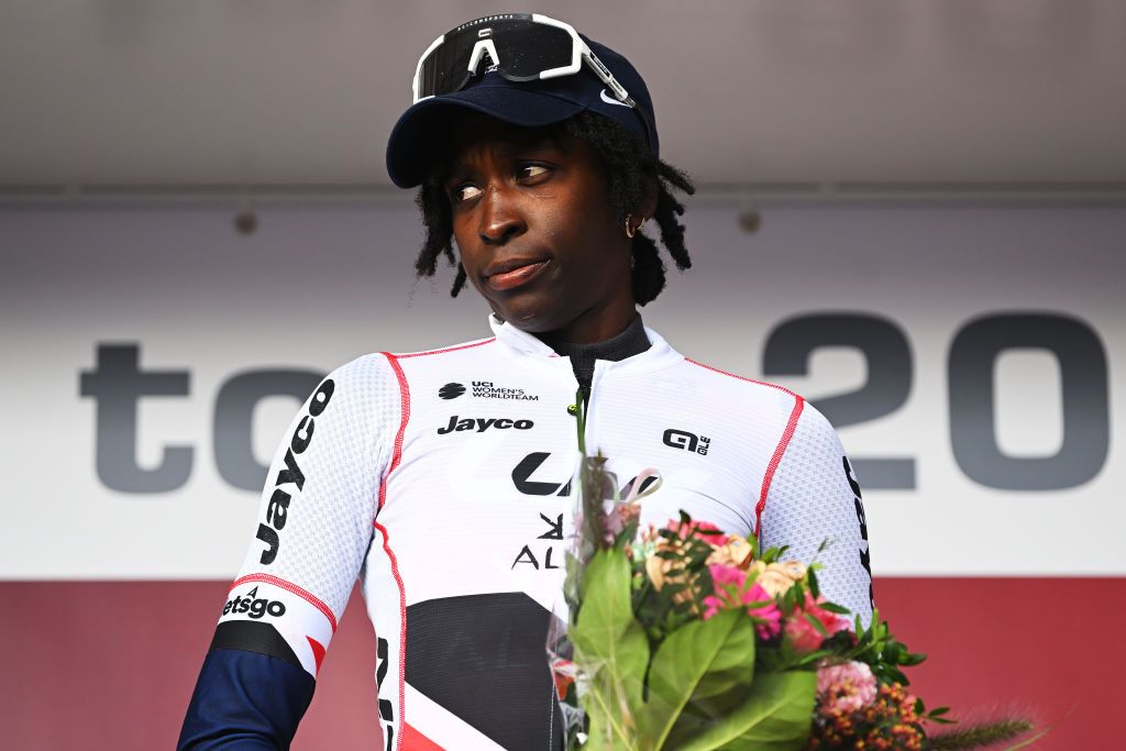 EDE NETHERLANDS OCTOBER 11 Teniel Campbell of Trinidad and Tobago and Team Liv AlUla Jayco celebrates at podium as Red most combative rider jersey winner during the 26th Simac Ladies Tour 2024 Stage 4 a 1182km stage from Ede to Ede UCIWWT on October 11 2024 in Ede Netherlands Photo by Luc ClaessenGetty Images