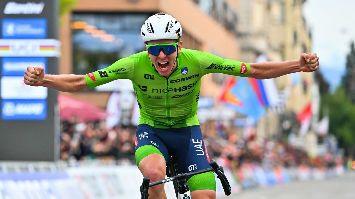 Slovenia&#039;s Tadej Pogacar, wearing lime green jersey, celebrates as he crosses the finish line on his bike ahead of the next big race: the Giro dell&#039;Emilia 2024 