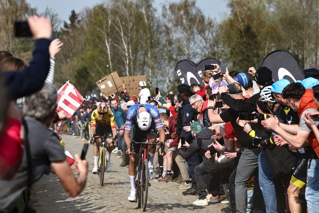 Spectators cheer AlpecinDeceuninck teams Dutch rider Mathieu Van Der Poel R and JumboVisma teams Belgian rider Wout Van Aert L cycle over the cobblestone sector during the 120th edition of the ParisRoubaix oneday classic cycling race between Compiegne and Roubaix northern France on April 9 2023 Photo by AnneChristine POUJOULAT AFP Photo by ANNECHRISTINE POUJOULATAFP via Getty Images