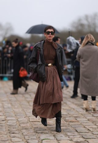 woman wearing brown dress leather jacket and boots