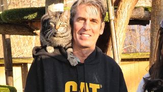 Chris Arsenault of Happy Cat Sanctuary with a cat on his shoulder